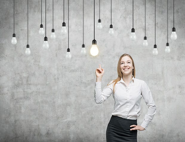 Woman pointing at lightbulb