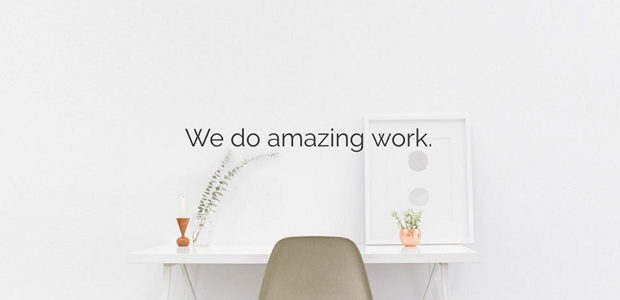 A neat white desk with sleek text reading 'We do amazing work.'