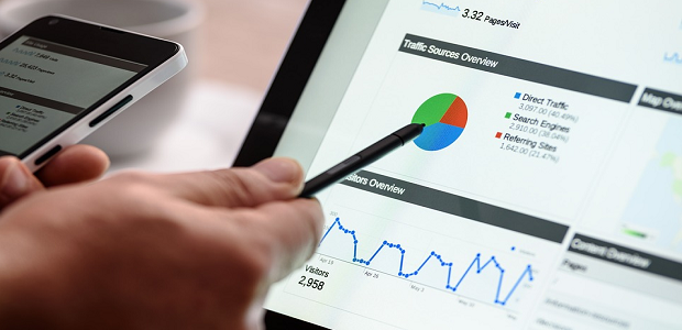 A traffic stat breakdown being displayed on a tablet, with someone pointing at a pie chart with a stylus