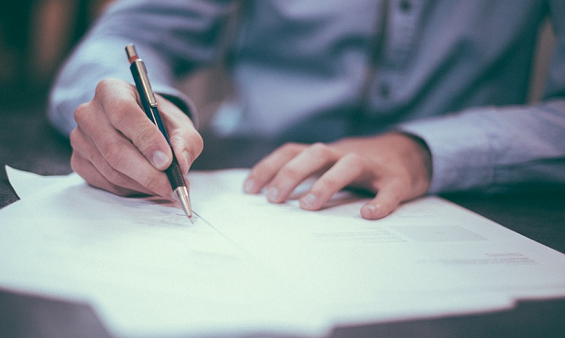 A businessman signing a document
