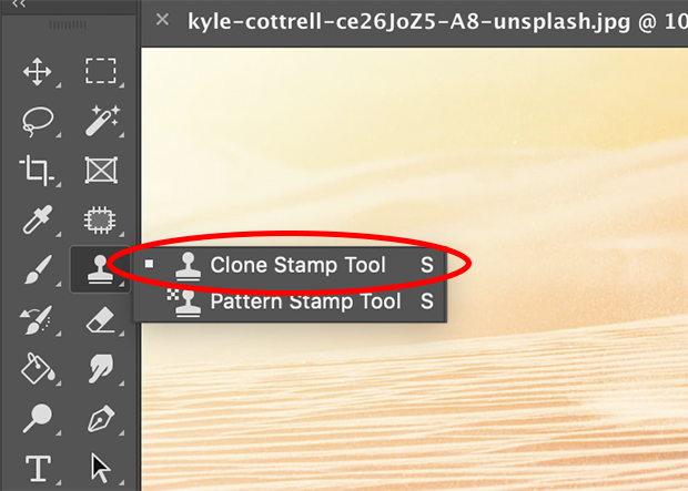 Photoshop's Clone Stamp Tool selected and circled in red