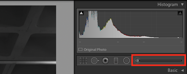 Lightroom's Adjustment Brush, located under the Histogram in the editing sidebar is highlighted with a red box.