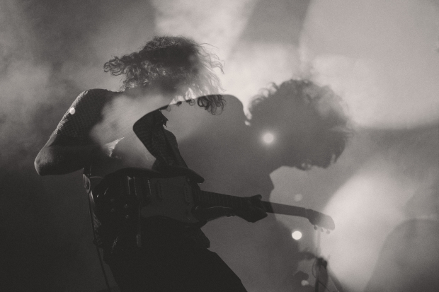 Double exposure black and white image of guitar player