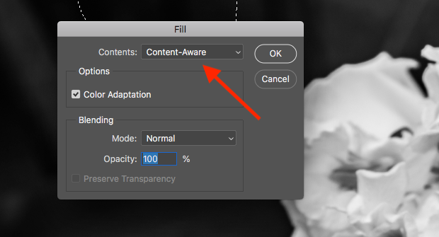 "Fill" dialog box open in Photoshop with red arrow pointed at "Content-Aware" contents option.