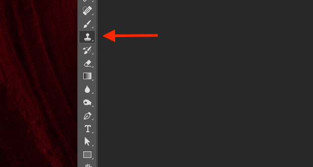 Red arrow pointed to Photoshop's Clone Stamp Tool icon in left-hand panel