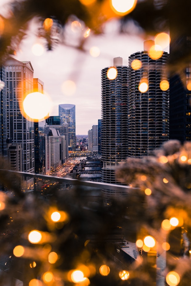 Skyscrapers of city scene visible through close-up glare of outdoor lights