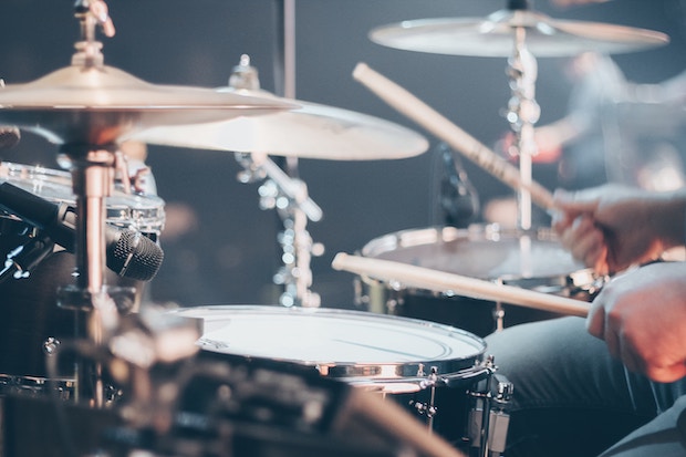 Close up of drum set with drummer playing