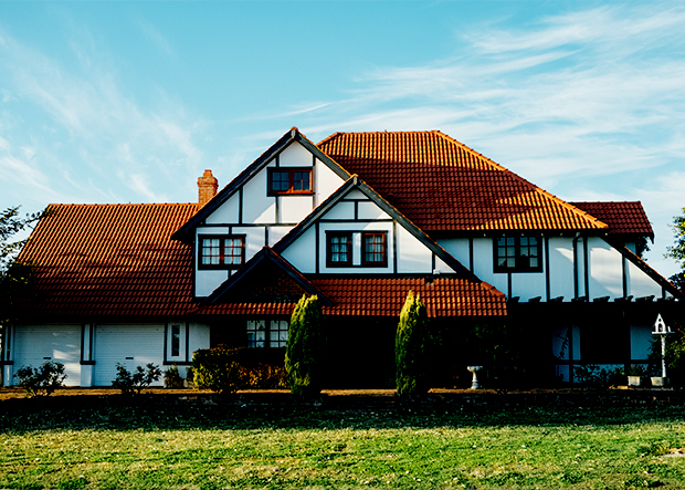 Exterior of cottage-style home with green lawn