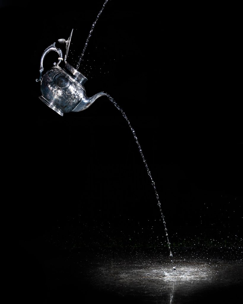 A teapot pouring water on the floor