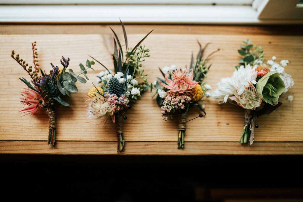 Different flowers tied together in four different bouquets