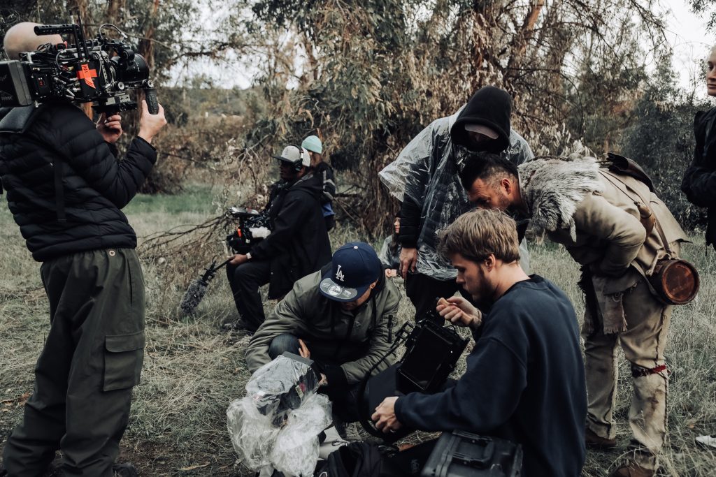 A photography team setting up the gear behind the scenes