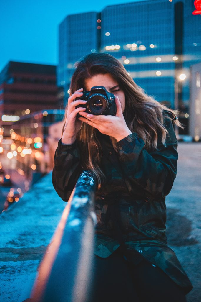 A woman holding a Canon's camera