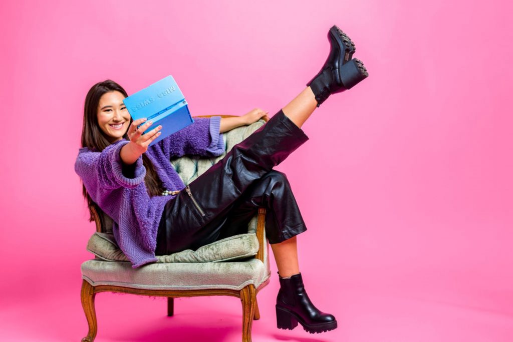 A model posing with the product during a product photography photo shoot