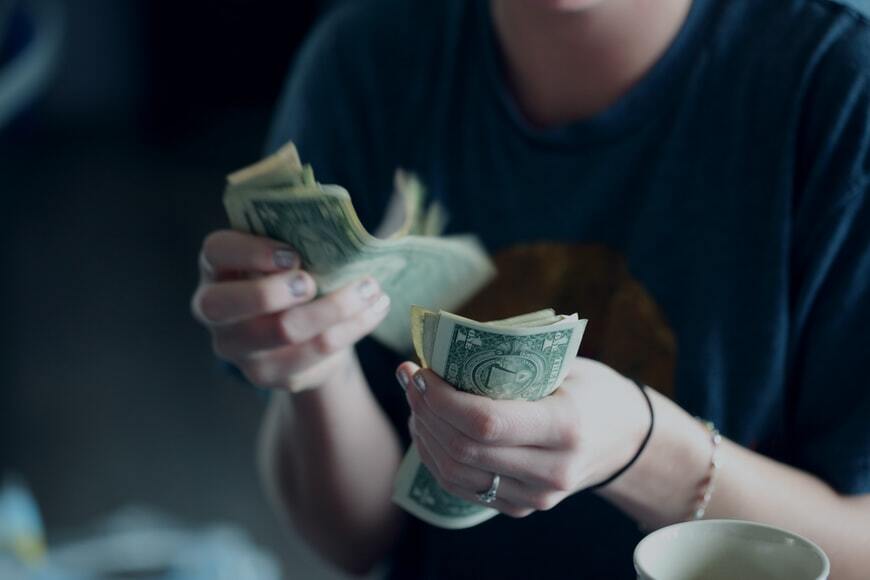 A close up shot of a person's hand counting cash