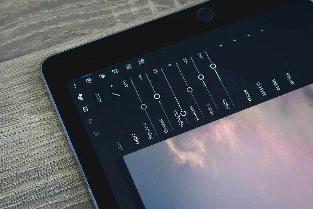 A close up of a tablet's screen displaying Adobe Lightroom settings