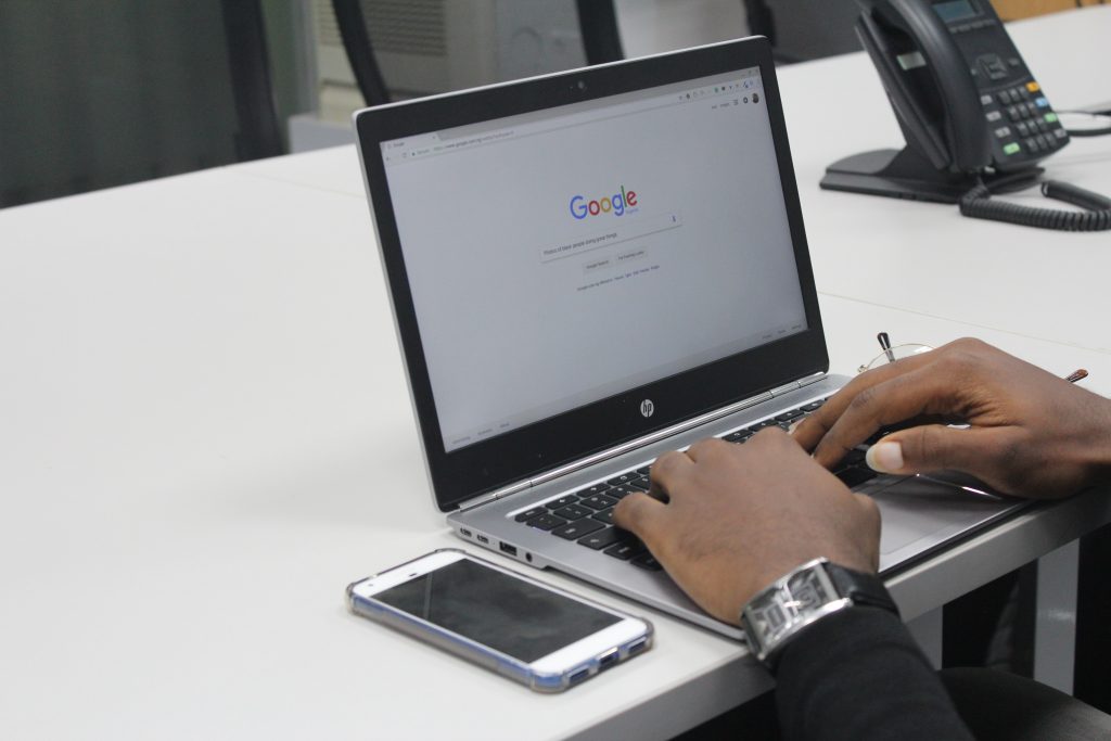 A person doing Google Search on a laptop