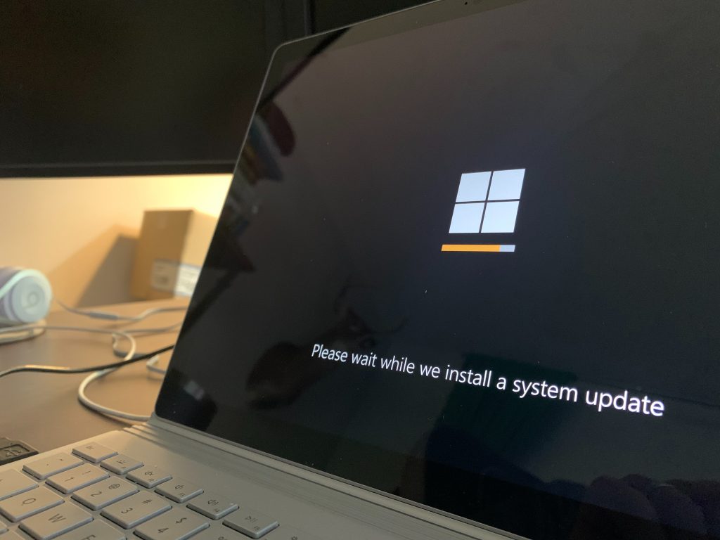 A close up shot of a laptop screen displaying a system update message